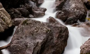 A series of rocks downstream from a waterfall
