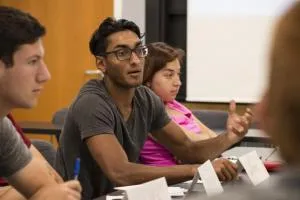 students at a table, discussing