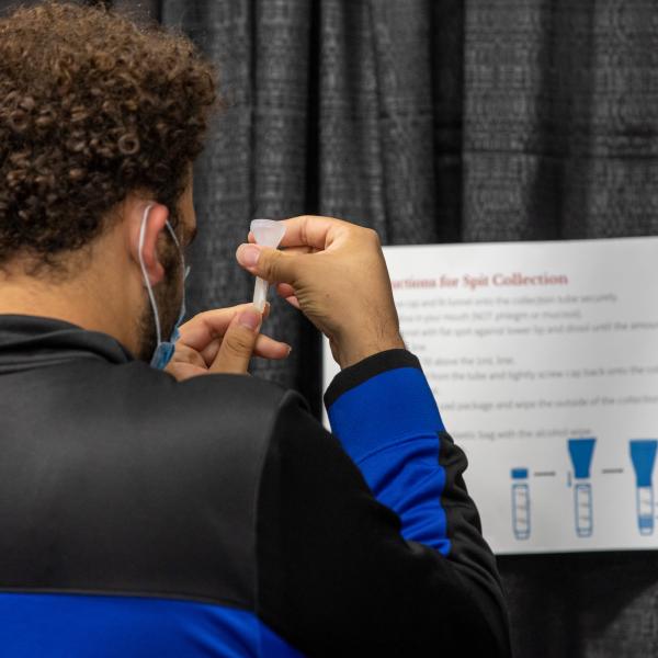 A student prepares a COVID-19 test. 