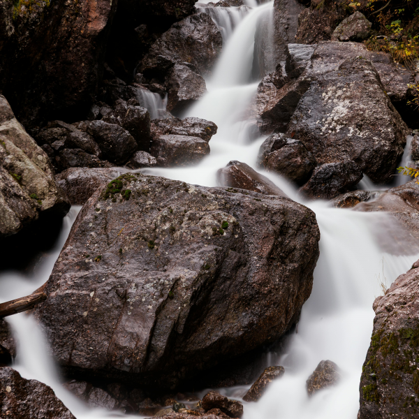 A series of rocks downstream from a waterfall