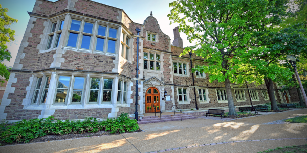 Front of a building with trees in the foreground