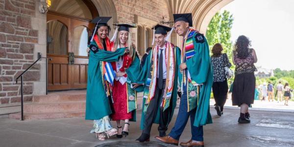 2025 graduates celebrate by pretending to step on the WashU seal.