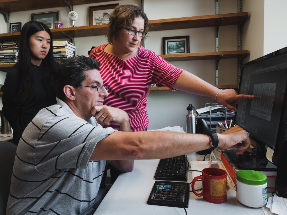 Todd Braver looks at brain scans with his students